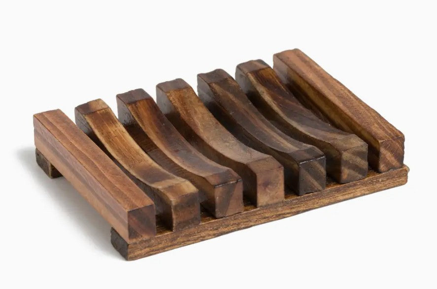 Dight wooden soap dish with slotted design on a white surface