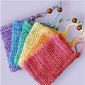 A collection of colorful sisal mesh bags displayed in a fan.